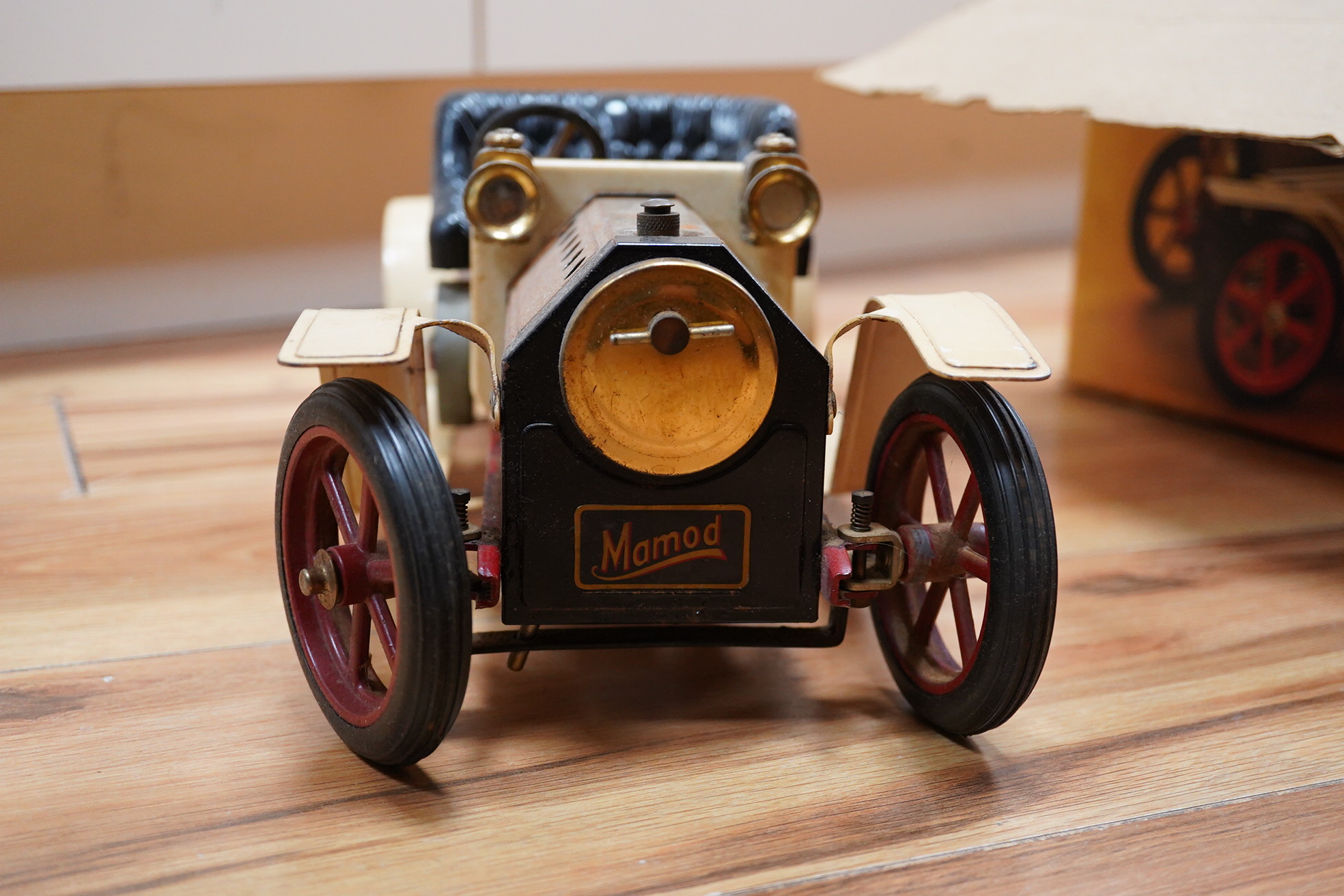 A boxed Mamod Steam Roadster, live steam, single cylinder cream painted car, together with some accessories